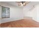 Cozy room with ceiling fan, hardwood floors, bright natural light, and view into other rooms at 221 N Ironwood St, Gilbert, AZ 85234