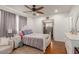 Well-lit bedroom with hardwood floors, decorative dresser, and a view of the walk-in closet at 3121 W Greenway Rd, Phoenix, AZ 85053