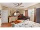 Cozy bedroom featuring hardwood floors, ceiling fan, and a large dresser with vanity mirror at 3121 W Greenway Rd, Phoenix, AZ 85053