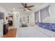 Bright bedroom with hardwood floors, fan, and a desk area, connected to another room at 3121 W Greenway Rd, Phoenix, AZ 85053