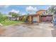 Home featuring an attached garage, well-manicured front lawn, and covered front porch at 3121 W Greenway Rd, Phoenix, AZ 85053