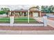 Charming single-Gathering home with a well-maintained lawn, decorative front fence, and covered entryway at 3121 W Greenway Rd, Phoenix, AZ 85053