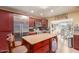 Modern kitchen featuring stainless steel appliances, a center island, and dark wood cabinetry at 3121 W Greenway Rd, Phoenix, AZ 85053