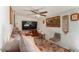 Cozy living room with a ceiling fan, comfortable seating, and a vintage-style rug at 3121 W Greenway Rd, Phoenix, AZ 85053
