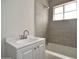 This bathroom has a bright white vanity and shower over the tub, with neutral toned walls at 3636 N 21St Ave, Phoenix, AZ 85015