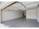 Well-lit garage featuring a smooth, epoxy-coated floor for durability and easy maintenance at 38070 W Merced St, Maricopa, AZ 85138