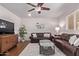 Living room showcasing hardwood floors, two leather sofas, a glass coffee table, and a wall-mounted TV at 425 E Del Rio Dr, Tempe, AZ 85282