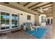 Covered patio with outdoor seating, fan, and a view of the pool, providing a comfortable outdoor space at 425 E Del Rio Dr, Tempe, AZ 85282