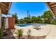 Backyard pool and patio area with dining table and chairs, with lush landscaping all around at 425 E Del Rio Dr, Tempe, AZ 85282