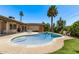 Backyard pool surrounded by lush greenery, with seating and lounging areas, under a clear blue sky at 425 E Del Rio Dr, Tempe, AZ 85282