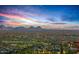 Breathtaking sunset view from this hillside home overlooking city lights and mountain ranges at 43105 N 102Nd St, Scottsdale, AZ 85262