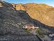 Luxury hillside home with red tile roof blends into a desert landscape with mountain views at 43105 N 102Nd St, Scottsdale, AZ 85262