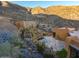 Aerial view of a Southwestern home, pool, and gardens with cacti and succulents against a mountain at 43105 N 102Nd St, Scottsdale, AZ 85262