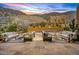 Serene backyard with a pool, comfortable seating, and breathtaking views of the desert landscape at sunset at 43105 N 102Nd St, Scottsdale, AZ 85262