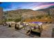 Relaxing backyard retreat with a pool, stylish patio furniture, and scenic desert surroundings at 43105 N 102Nd St, Scottsdale, AZ 85262
