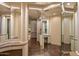 Elegant dressing room with mirrored walls, built-in vanity, and natural light at 43105 N 102Nd St, Scottsdale, AZ 85262