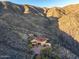 An exterior view of a desert home nestled in the hillside with mountain views at 43105 N 102Nd St, Scottsdale, AZ 85262