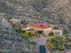 Exterior of a modern desert home featuring stone accents and lush desert landscaping at 43105 N 102Nd St, Scottsdale, AZ 85262