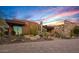 Exterior view showcasing modern architecture, desert landscaping, and colorful sunset skies at 43105 N 102Nd St, Scottsdale, AZ 85262