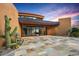 Beautiful modern home entrance with desert landscaping, featuring a unique stone driveway and native plants at 43105 N 102Nd St, Scottsdale, AZ 85262