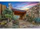 Inviting home featuring a grand stone entrance with desert landscaping and a view through a glass front door at 43105 N 102Nd St, Scottsdale, AZ 85262