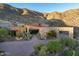 A luxurious desert home with stone accents, desert landscaping, and scenic mountain views at 43105 N 102Nd St, Scottsdale, AZ 85262