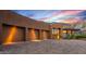 A modern home with a three-car garage, desert landscaping, and views of the surrounding hillsides at 43105 N 102Nd St, Scottsdale, AZ 85262