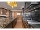 Modern kitchen with a large island, granite countertops, a tile backsplash, and stainless steel appliances at 43105 N 102Nd St, Scottsdale, AZ 85262
