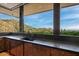 Kitchen features granite counters, a large sink, and a picture window view of the desert landscape at 43105 N 102Nd St, Scottsdale, AZ 85262