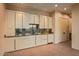 Modern kitchenette boasts sleek white cabinetry, granite countertops, and stylish backsplash for sophisticated entertaining at 43105 N 102Nd St, Scottsdale, AZ 85262