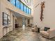 Elegant living area with high ceilings, clerestory windows, tile flooring, and comfortable seating at 43105 N 102Nd St, Scottsdale, AZ 85262