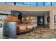 Open-concept living area with wet bar, high ceilings, expansive windows, and tile flooring throughout at 43105 N 102Nd St, Scottsdale, AZ 85262