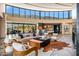 Expansive living room with large windows, comfortable seating, bar, and striking decor at 43105 N 102Nd St, Scottsdale, AZ 85262