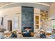 Modern living room with stone accent wall, statement fireplace, and contemporary furniture arrangement at 43105 N 102Nd St, Scottsdale, AZ 85262