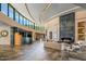 Open-concept living room with fireplace, modern decor, and floor-to-ceiling curved windows at 43105 N 102Nd St, Scottsdale, AZ 85262