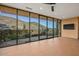 Spacious living room with expansive glass doors showcasing stunning mountain views and abundant natural light at 43105 N 102Nd St, Scottsdale, AZ 85262