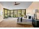 Bright main bedroom with comfortable seating, large windows with mountain views, and stylish ceiling fan at 43105 N 102Nd St, Scottsdale, AZ 85262