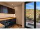 Office with built-in desk and storage, plus a patio view at 43105 N 102Nd St, Scottsdale, AZ 85262