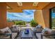 Inviting covered patio with comfortable seating and desert views, perfect for outdoor relaxation and entertaining at 43105 N 102Nd St, Scottsdale, AZ 85262