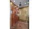 Modern shower with glass enclosure, copper accents, and tile flooring offers a spa-like experience at 43105 N 102Nd St, Scottsdale, AZ 85262