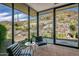 Inviting sun room with black chairs, large windows, and mountain views at 43105 N 102Nd St, Scottsdale, AZ 85262