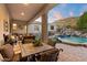 Outdoor patio with dining, seating and a pool with rock waterfall feature at 6621 N Arizona Biltmore Cir, Phoenix, AZ 85016