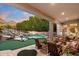 Backyard patio with pool, rock waterfall, putting green and outdoor seating at 6621 N Arizona Biltmore Cir, Phoenix, AZ 85016