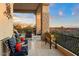 Expansive covered balcony features bench seating, tile floors, and stone pillars framing scenic vistas at 6621 N Arizona Biltmore Cir, Phoenix, AZ 85016