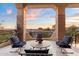 Outdoor balcony with stone columns, seating, tile floors, and picturesque sunset views at 6621 N Arizona Biltmore Cir, Phoenix, AZ 85016