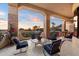 Spacious outdoor balcony features sunset views, stone columns, seating, and tile flooring at 6621 N Arizona Biltmore Cir, Phoenix, AZ 85016