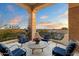 Spacious balcony with tile flooring, stone pillars, seating, and sunset views at 6621 N Arizona Biltmore Cir, Phoenix, AZ 85016