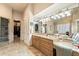 Elegant bathroom boasts marble floors, granite counters, and a mirror that spans the vanity at 6621 N Arizona Biltmore Cir, Phoenix, AZ 85016