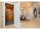 Elegant dining room featuring an elevator, chandelier, and arched doorway, showcasing luxurious living at 6621 N Arizona Biltmore Cir, Phoenix, AZ 85016