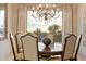 Elegant dining room boasts a chandelier, ample light, and seating for six at 6621 N Arizona Biltmore Cir, Phoenix, AZ 85016